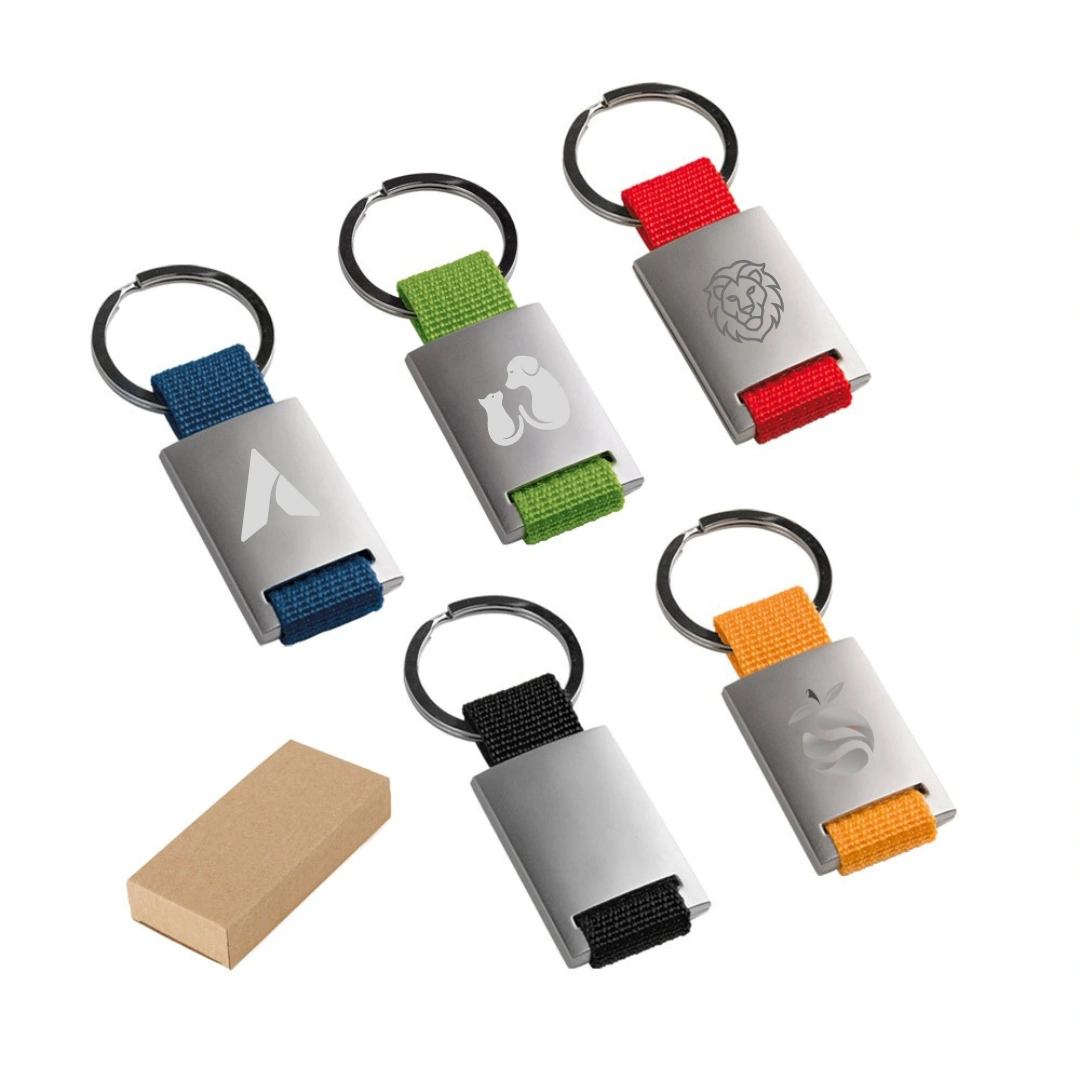 Chaveiro Metal e Webbing - Chaveiro em metal com alça em webbing colorida. Personalização em gravação a laser.